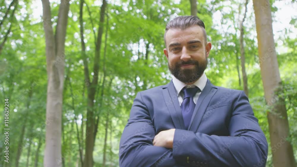 Portrait of smiling hipster businessman standing in the woods Portrait of smiling hipster businessman standing in the woods