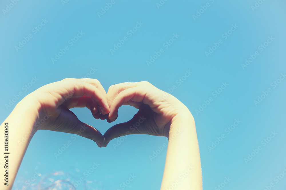 Silhouette of heart made by kids hand agianst sky Silhouette of heart made by kids hand agianst sky