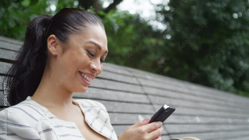 Portrait of beautiful woman looking at mobile phone outdoors in the city Portrait of beautiful woman looking at mobile phone outdoors in the city