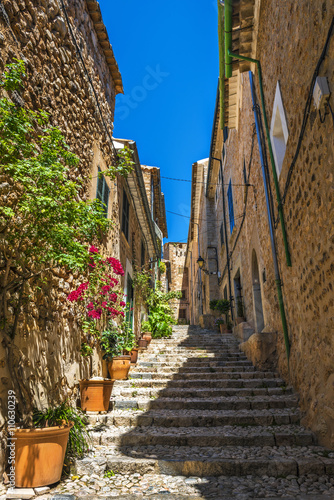 Narrow street with traditional stone houses in Fornalutx