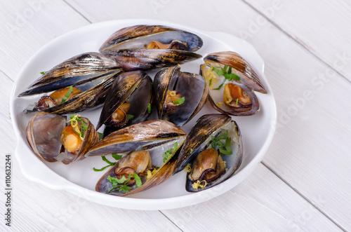 Mussels in a white plate with parsley
