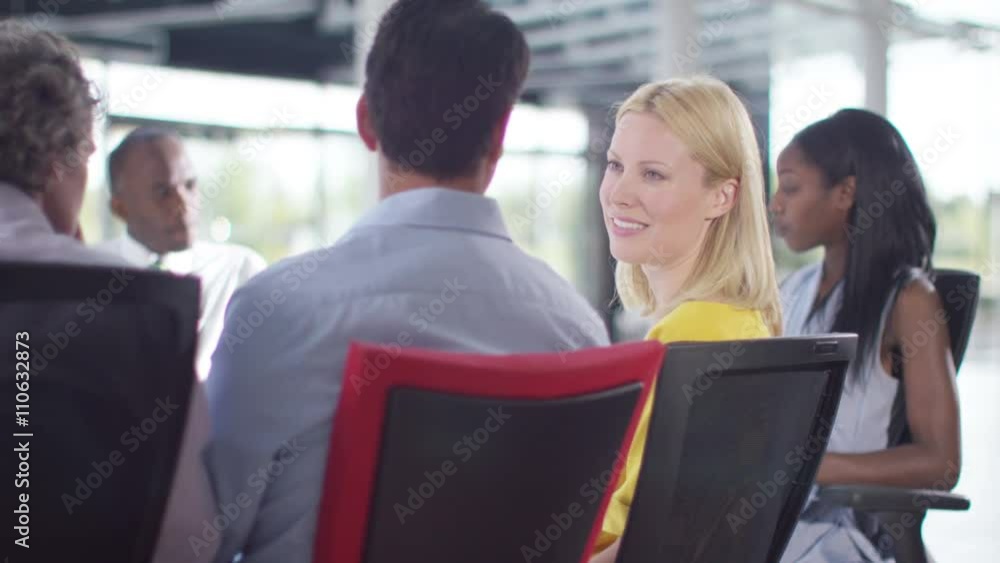 Attractive mixed ethnicity business group discuss ideas in office meeting Attractive mixed ethnicity business group discuss ideas in office meeting