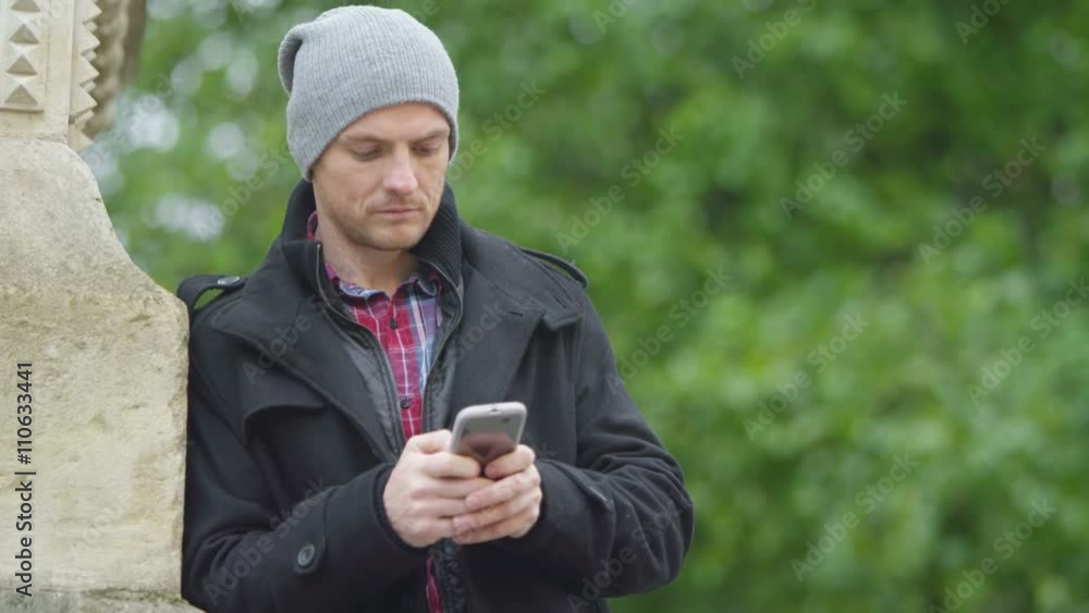 Portrait of casual smiling man making mobile phone call outdoors in the city Portrait of casual smiling man making mobile phone call outdoors in the city