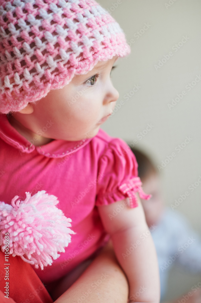 little baby girl in a knitted hat on hands at mum little baby girl in a knitted hat on hands at mum