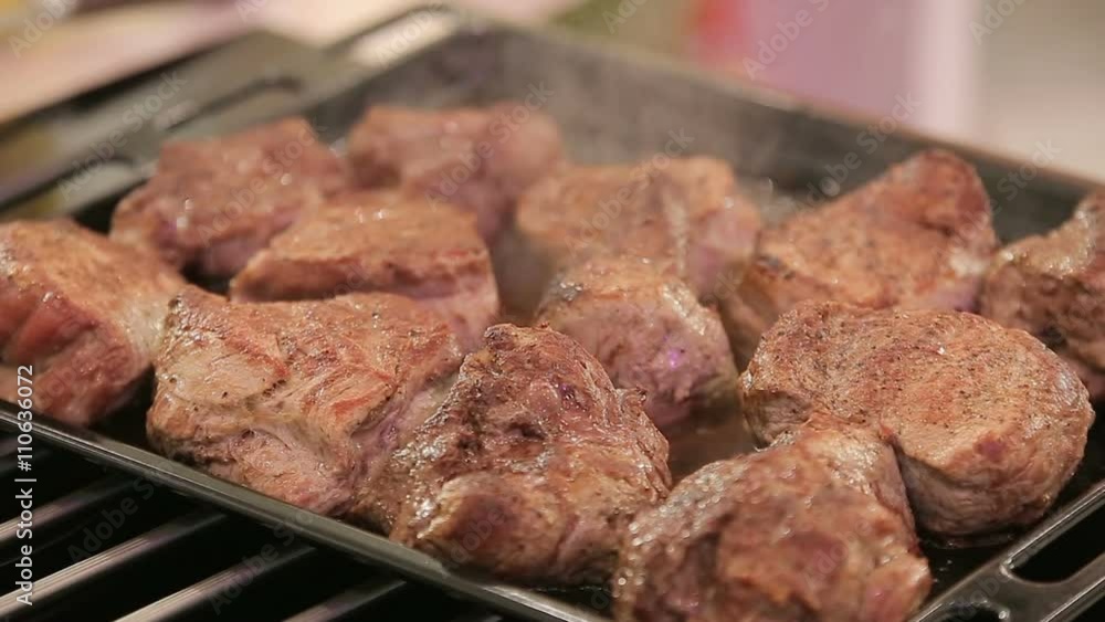Smoky fried steakes in a pan Smoky fried steakes in a pan