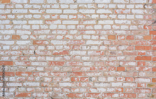 wall of red bricks in whitewashing