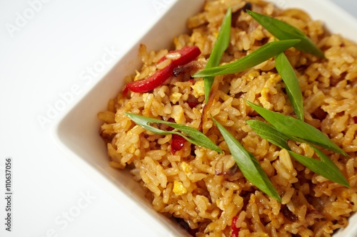 Asian fried rice with green onion, close-up on a plate