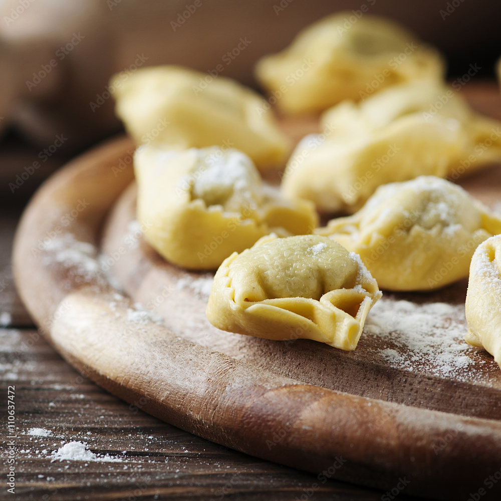 Italian traditional tortellini on the wooden table Italian traditional tortellini on the wooden table