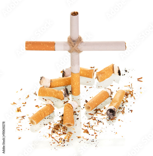 The composition in the form of  cross, and smoked cigarette isolated on white 