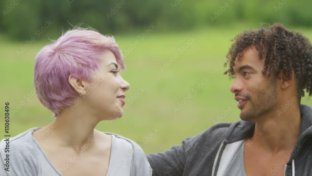Portrait of happy couple outdoors embracing and smiling to camera Portrait of happy couple outdoors embracing and smiling to camera