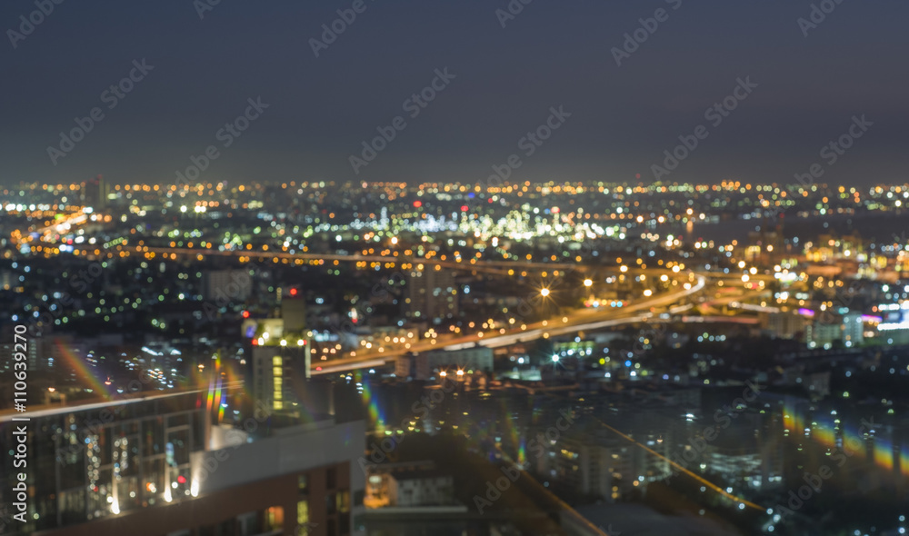 De-focused scene of the buildings and expressways in Bangkok city business area with blue sky twilight on sunsets, background is refinery plant nearby the expressway.