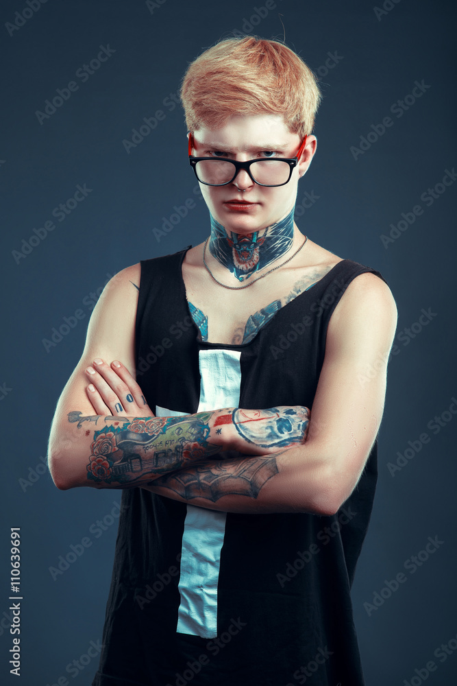 A young blond man in glasses with a pierced nose and a tattoo is back. The  concept of thoughtfulness, seriousness, confidence Stock Photo | Adobe Stock
