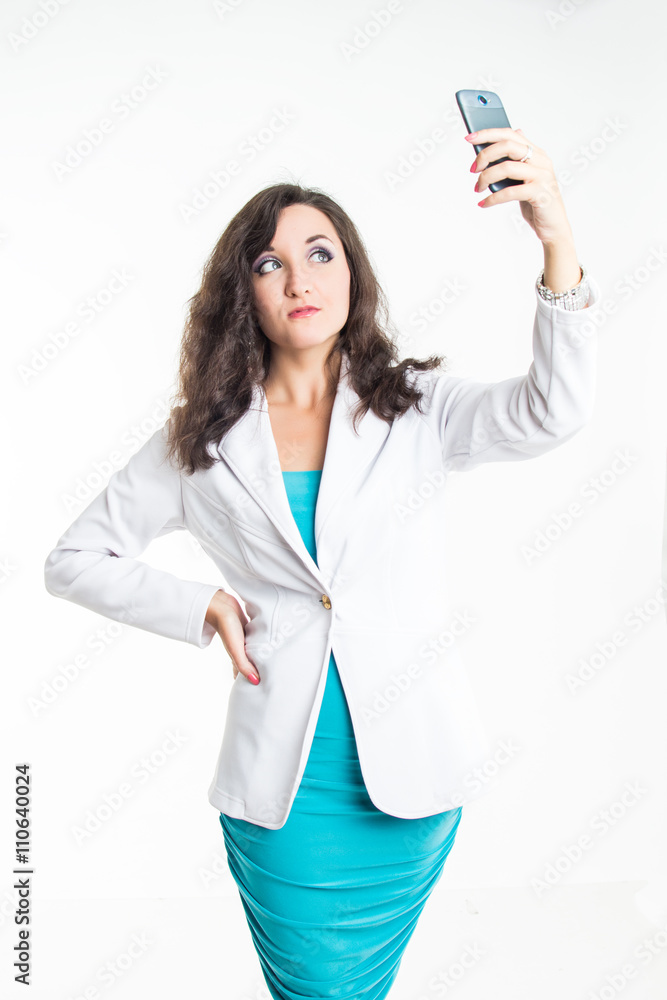 Beautiful lady in white jacket making a photo on telephone isolated on white background Beautiful lady in white jacket making a photo on telephone isolated on white background
