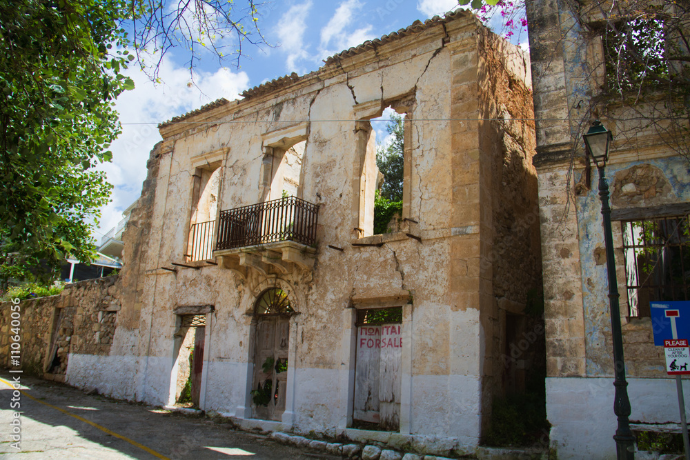 Facade of an abandoned house in Assos on the Greek ionian island Kefalonia, damaged by an earthquake in 1953, Venetian architecture