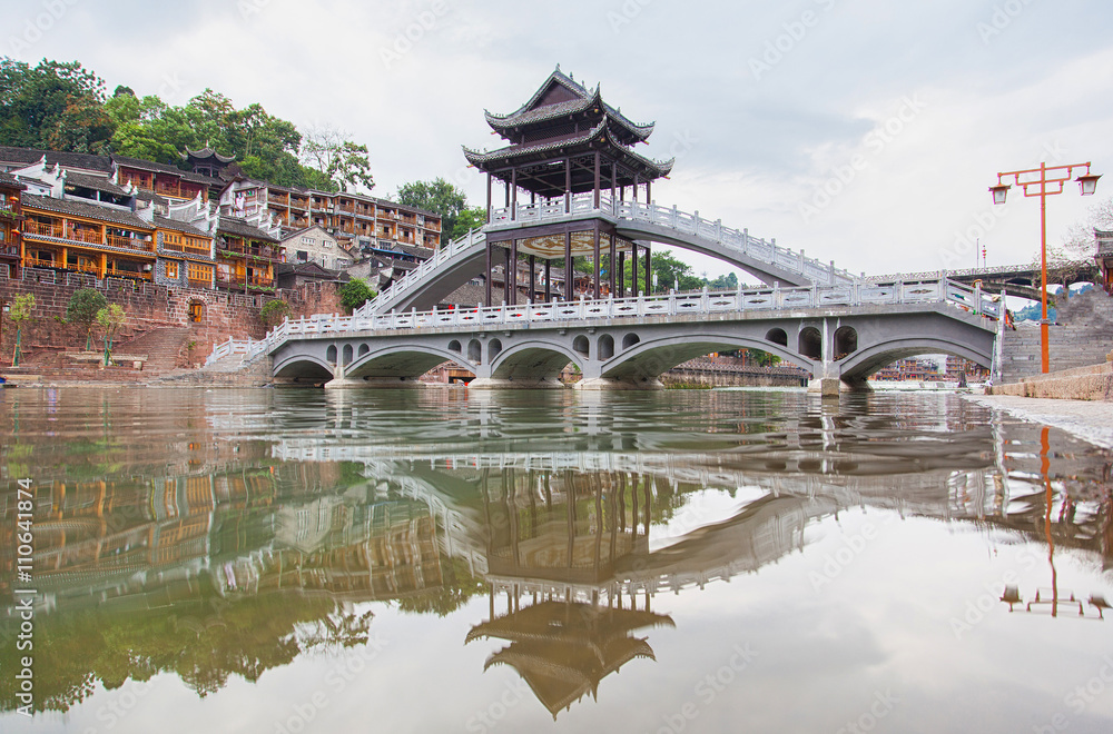 The Old Town of Phoenix (Fenghuang Ancient Town). The popular tourist attraction which is located in Fenghuang County. HuNan, China. Focus on bridge. The Old Town of Phoenix (Fenghuang Ancient Town). The popular tourist attraction which is located in Fenghuang County. HuNan, China. Focus on bridge.