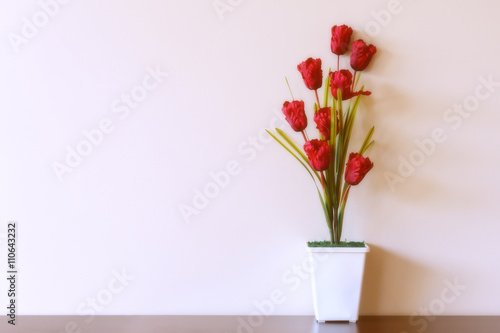 A vase of flowers against the background of beige walls