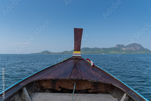 Thai wooden head longtail boat heads toward