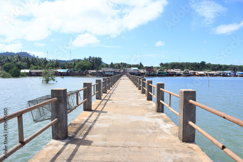 old wooden and concrete bridge to dock pier tranquil sea destination,Trang Thailand © chochowy