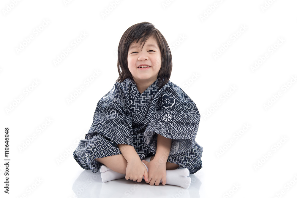 Happy asian boy in kimono sitting