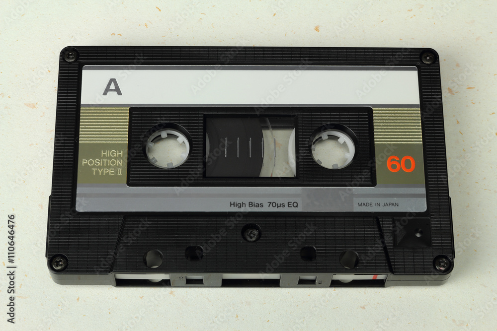 Obraz premium Audio Compact Cassette C60 tape with a blank label on a colored background