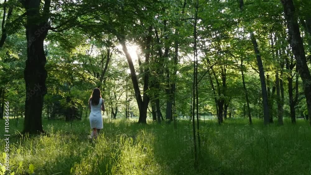 Woman with a bouquet of flowers in the morning wood Woman with a bouquet of flowers in the morning wood