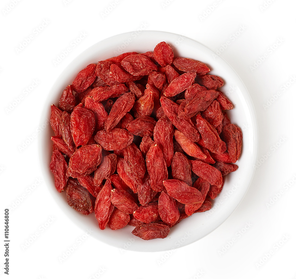 Bowl of goji berries isolated on white, from above