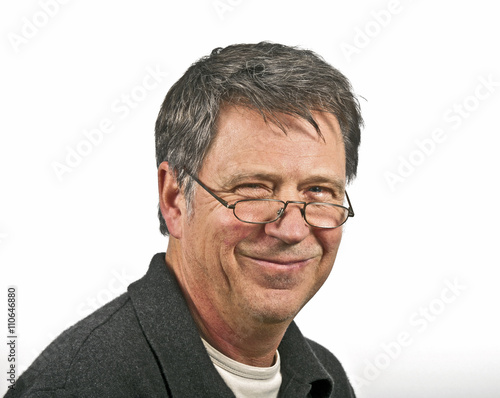 smiling man with reading glasses