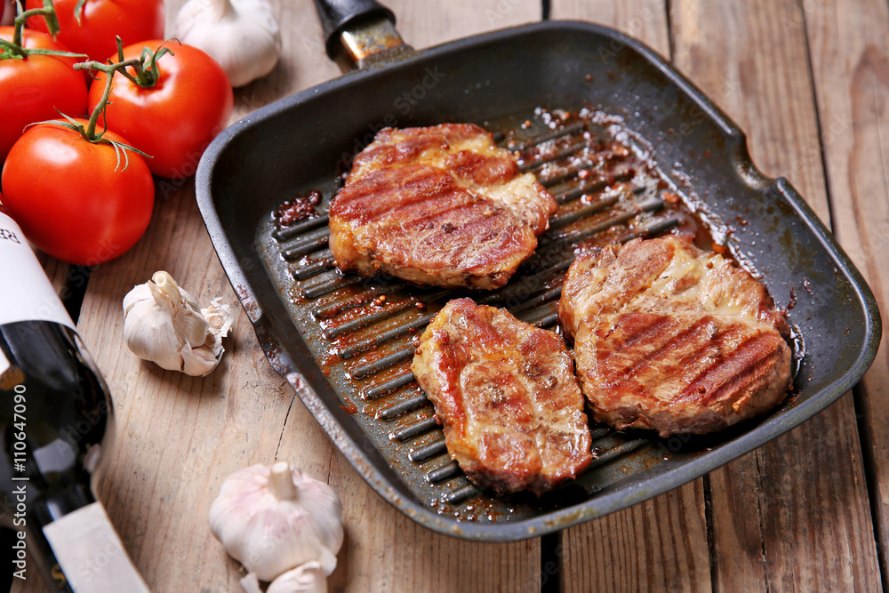 Roasted beef fillet on pan, on wooden background Roasted beef fillet on pan, on wooden background