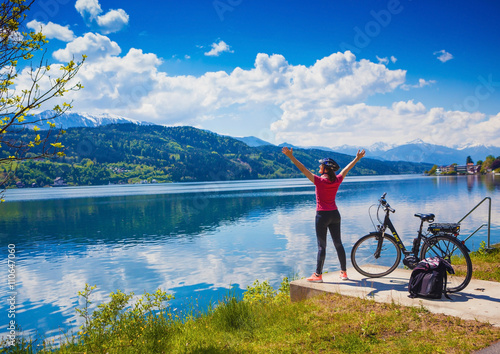 woman with e-bike enjoying view over lake-lake and bike 02