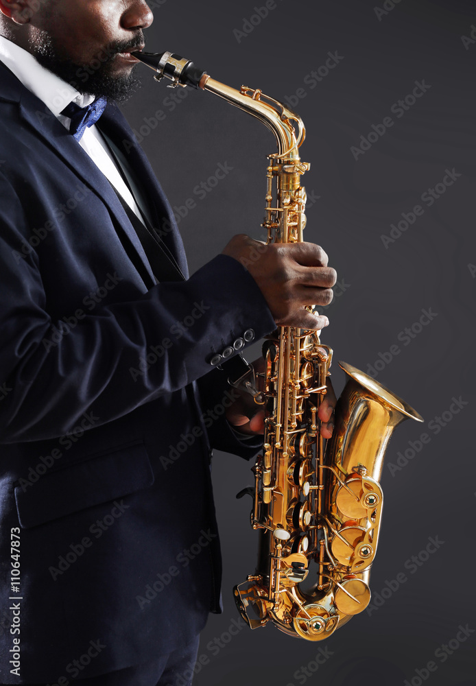 Naklejka premium African American jazz musician playing the saxophone, closeup