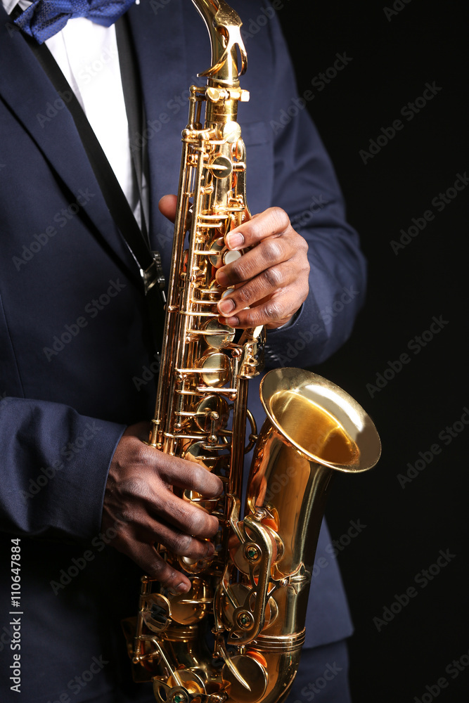 Fototapeta premium African American jazz musician playing the saxophone, closeup