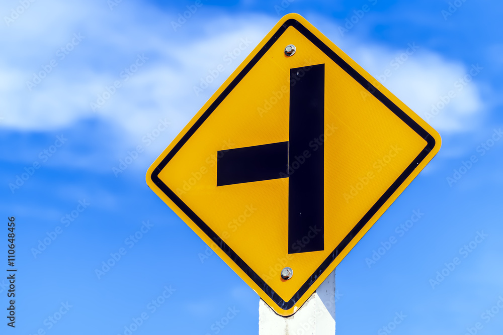 Left junction road signpost isolated on sky background Left junction road signpost isolated on sky background