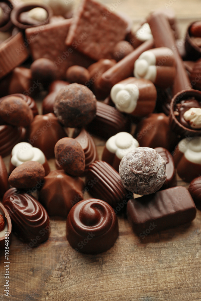 Assortment of delicious chocolate candies background, close up Assortment of delicious chocolate candies background, close up
