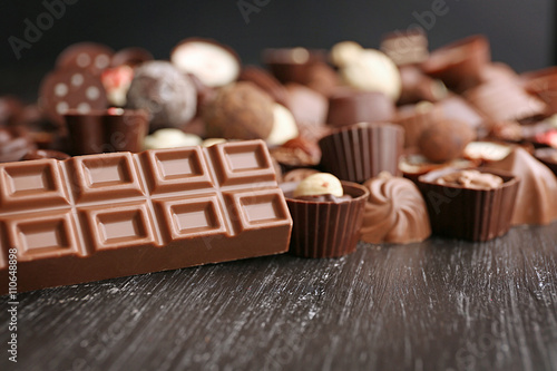 Delicious chocolate candies on wooden background