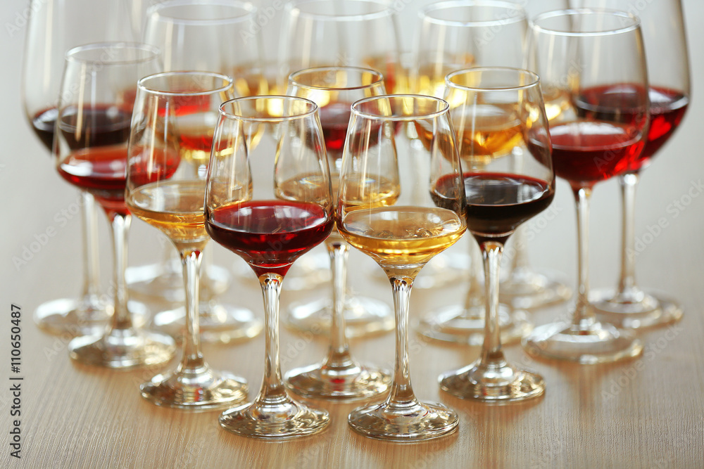 Many glasses of different wine on a table