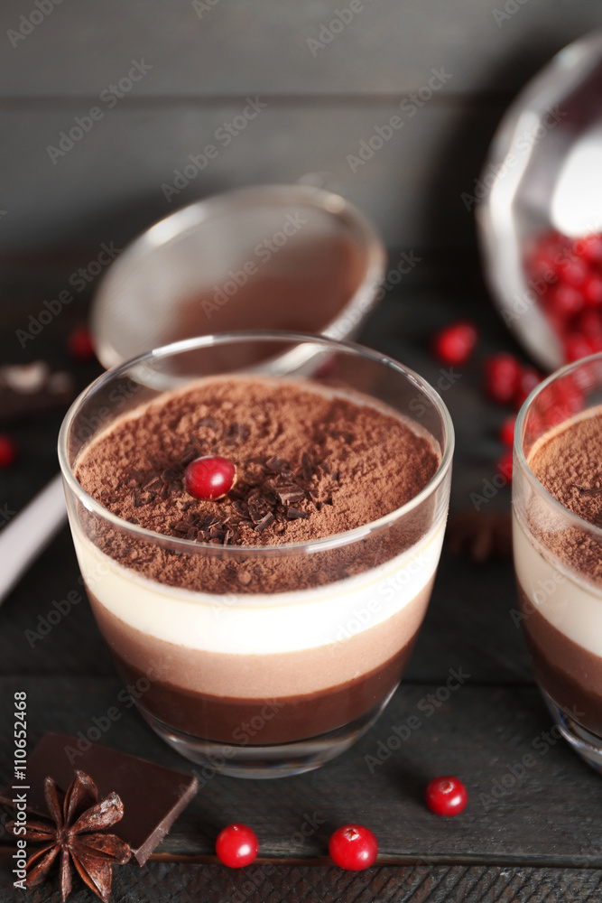 Delicious dessert with chocolate powder and rowan in glass Delicious dessert with chocolate powder and rowan in glass