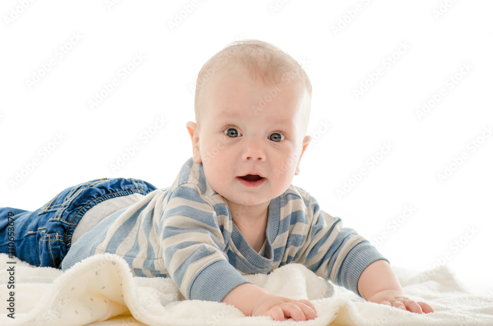 Infant baby boy smiling on a white blanket isolated on white bac Infant baby boy smiling on a white blanket isolated on white bac