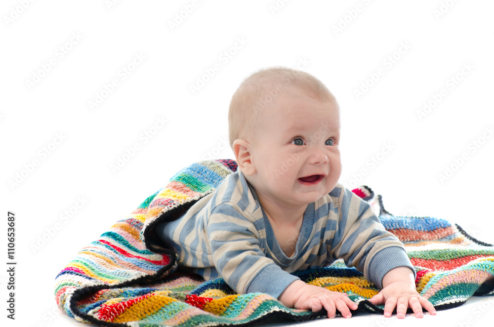 Sweet baby boy on colorful blanket crying isolated on white back Sweet baby boy on colorful blanket crying isolated on white back