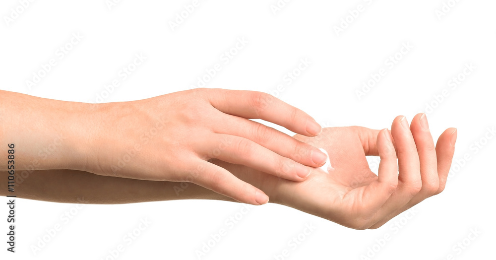 Beautiful female hands applying hand cream, isolated on white Beautiful female hands applying hand cream, isolated on white