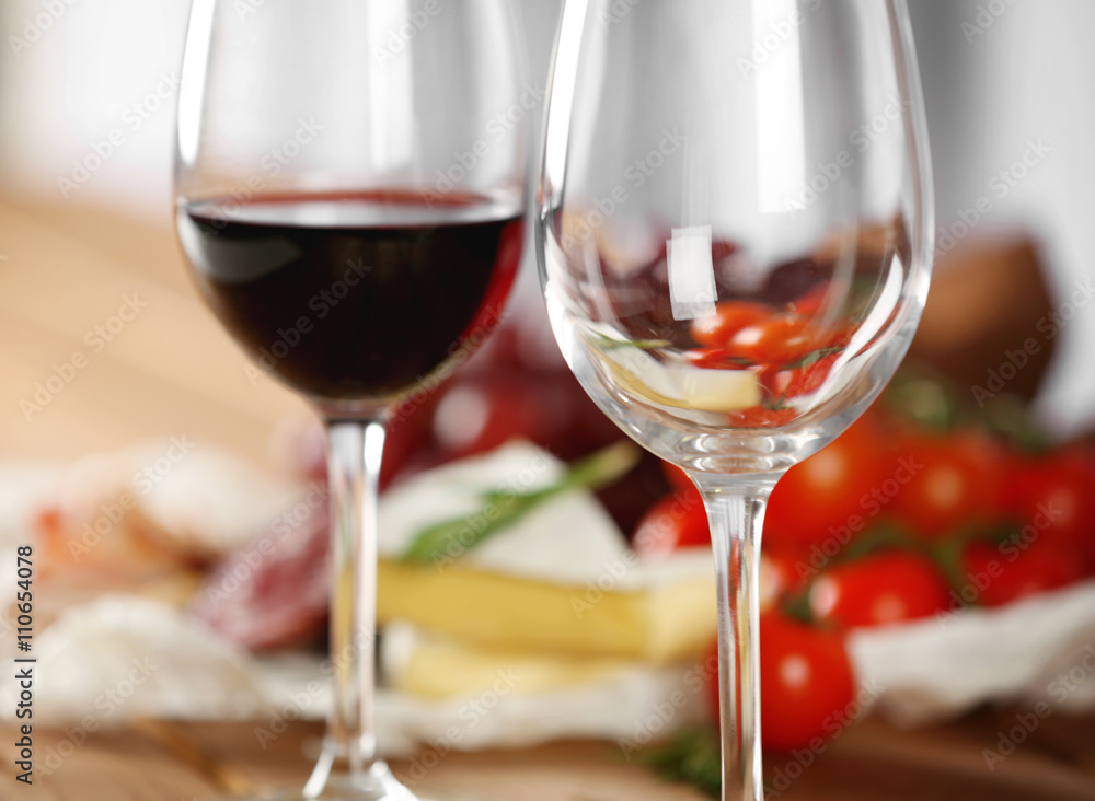 Glasses of wine with food on table closeup