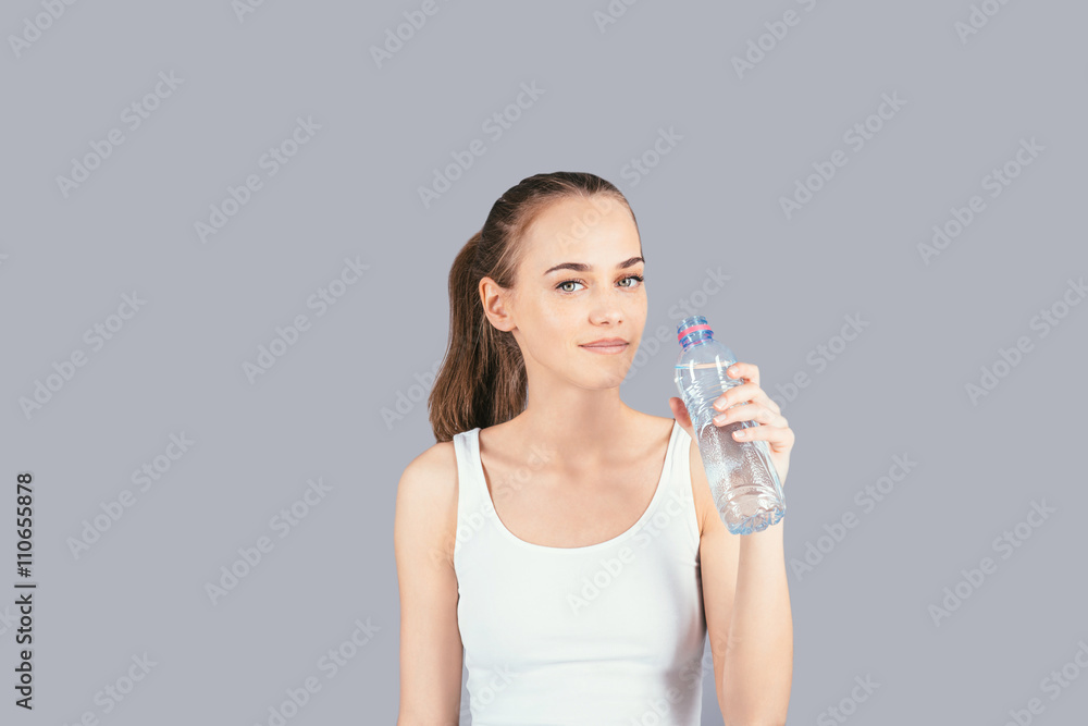Cheerful girl with a bottle of water Cheerful girl with a bottle of water