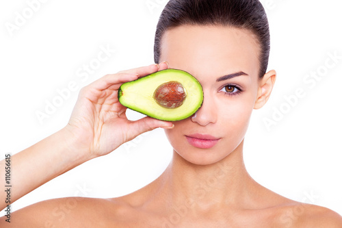 Taking care of your skin the natural way. Studio portrait of a beautiful young woman posing with an avocado over white isolated background