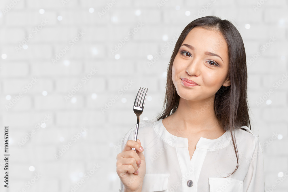 Portrait of young smiling woman with fork in her mouth Portrait of young smiling woman with fork in her mouth
