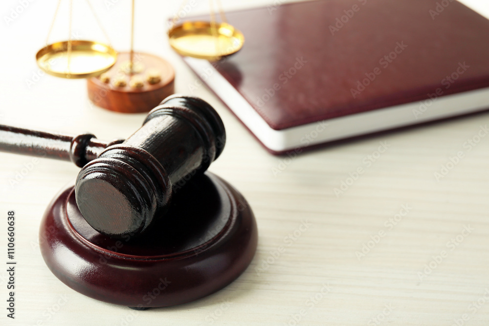 Gavel with book and scales on wooden background Gavel with book and scales on wooden background