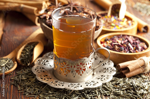Glass of tea and dried tea leaves