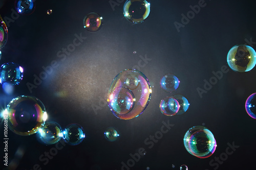 Rainbow soap bubbles on a dark backgrounds