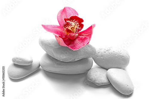 White spa stones and red orchid isolated on white