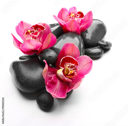 Spa stones and red orchid isolated on white