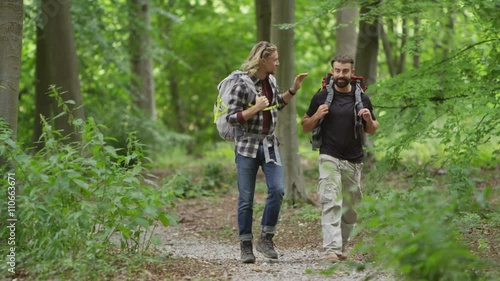 Wallpaper Mural  Cheerful male friends hiking in the woods, chatting as they walk.  Torontodigital.ca