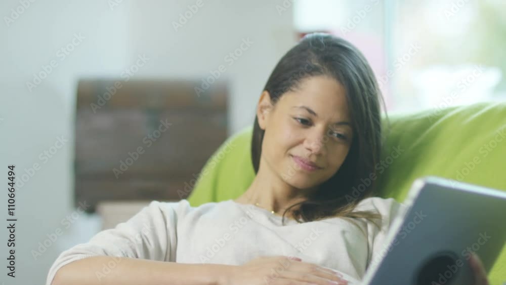 Affectionate pregnant couple relaxing at home with tablet computer Affectionate pregnant couple relaxing at home with tablet computer